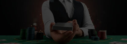 casino dealer holding the cards out as if to start dealing with chips and cards on the poker table