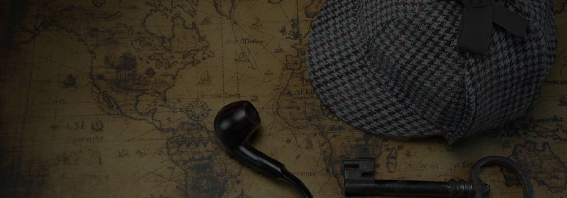 Sherlock Holmes hat, vintage key and a smoking pipe lying on top of an Old World Map