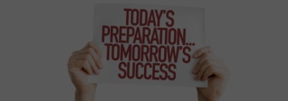 hand holding sign in maroon letters "today's preparation...tomorrow's success"