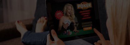 woman relaxing on her sofa playing online poker on her tablet