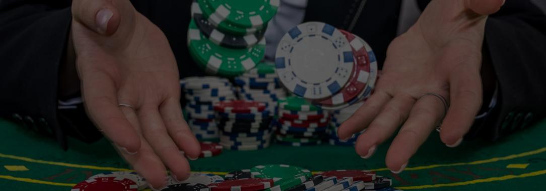 close-up photo of two hands throwing extra chips on a poker table