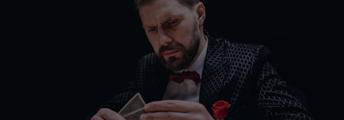 man looking at his poker hand