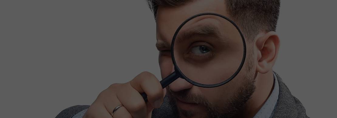 man looking through a magnifying glass trying to understand his opponents