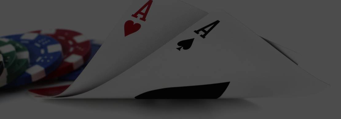 A pair of aces with green, blue and red casino chips