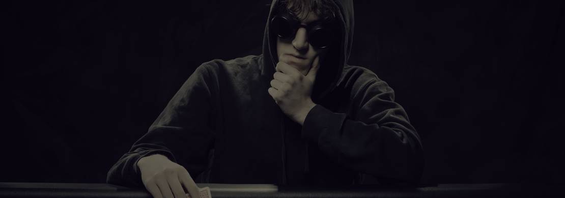 Poker player sitting at a poker table thinking before his next move
