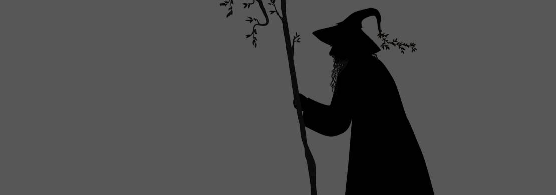 silhouette of a wizard walking with a stick